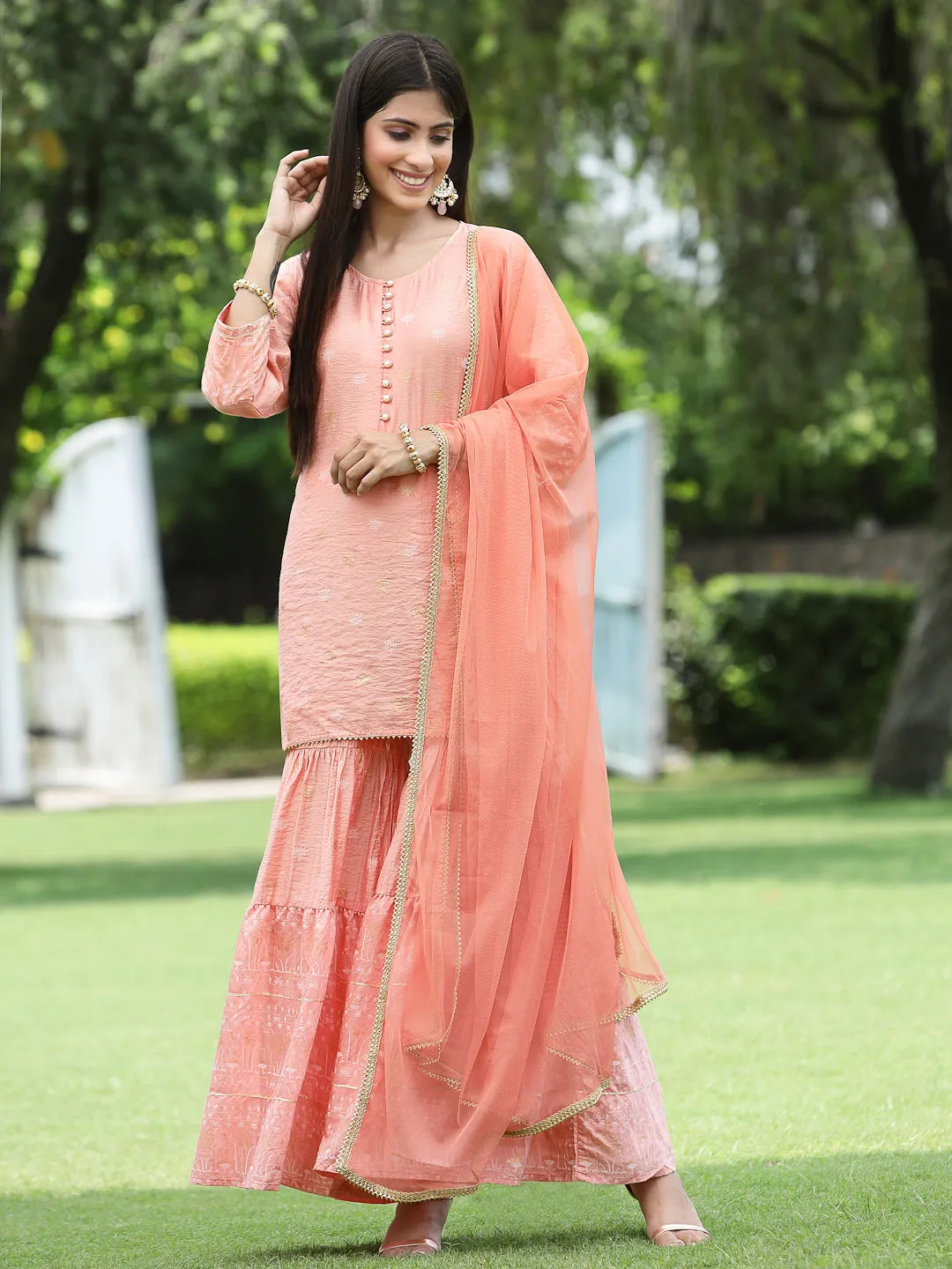 Juniper Peach Ethnic Motif Printed Viscose Muslin Kurta Sharara & Net Dupatta Set.